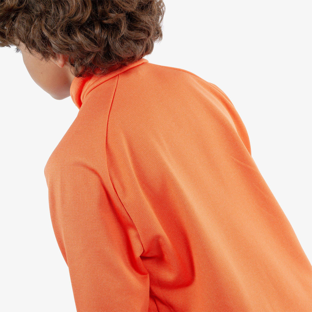 Raz is a Insulating golf mid layer for Juniors in the color Orange(5)